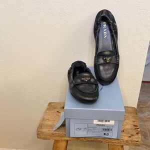 Prada Black Distressed Leather Logo Loafers with Gold Triangle Hardware